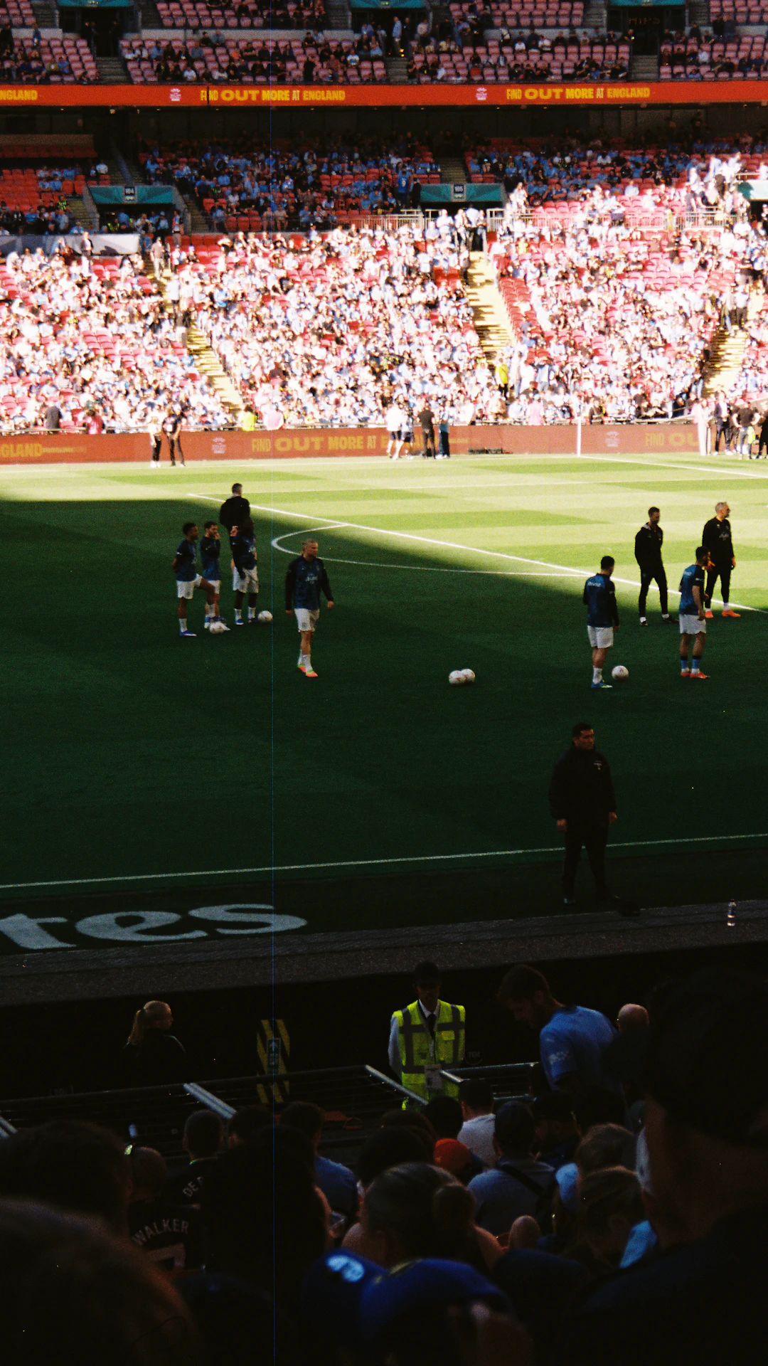 Soccer players warming up on a green field.