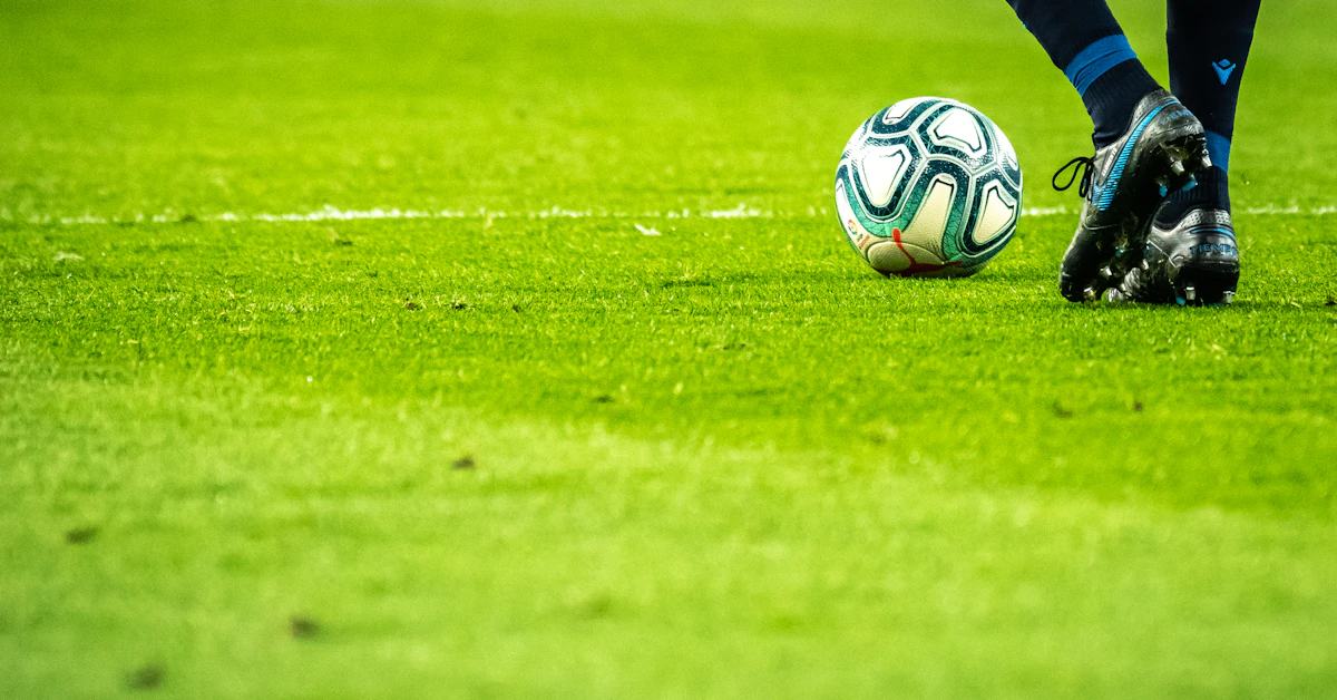 man playing soccer game on field